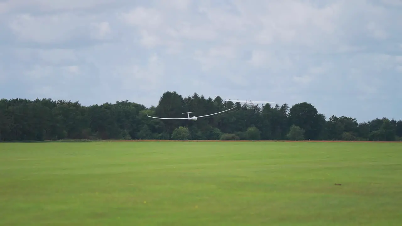 A light plane tows the glider high up into the stormy sky from the ground