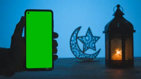 Wide Shot of Lantern Dates and Water with Green Screen Phone at Dusk