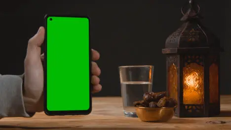 Wide Shot of Lantern Dates and Water with Green Screen Phone