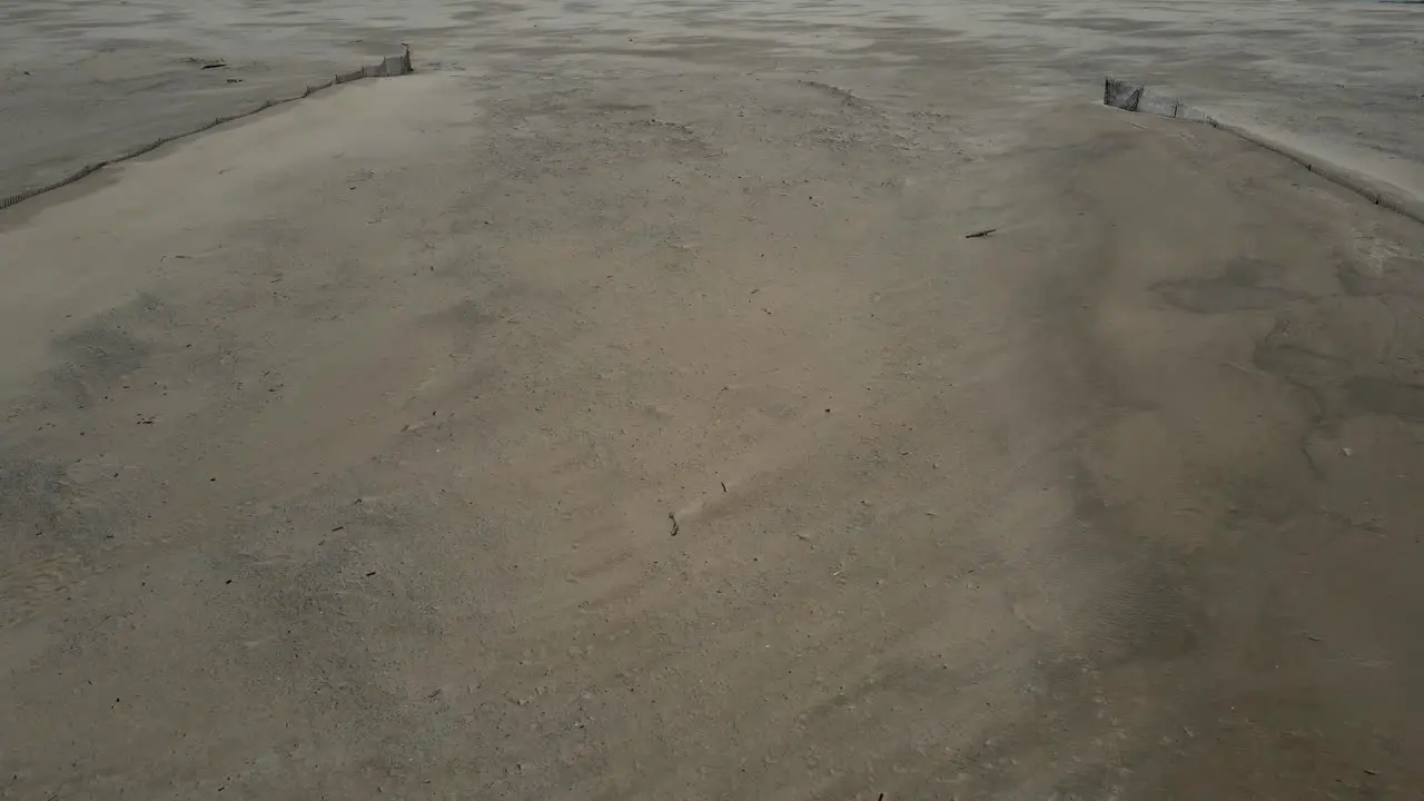 Ran soaked sand on a lovely beach during a storm