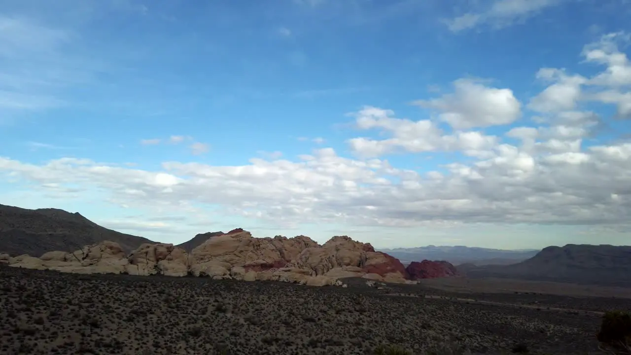 Slow wide pan over Red Rocks Canyon from Red Rock Canyon Overlook Las Vegas Nevada on a sunny spring day