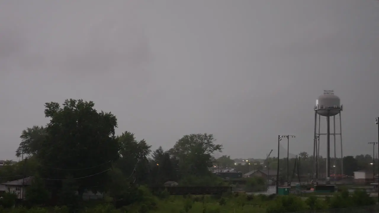 Water tower in a park during a thunder storm