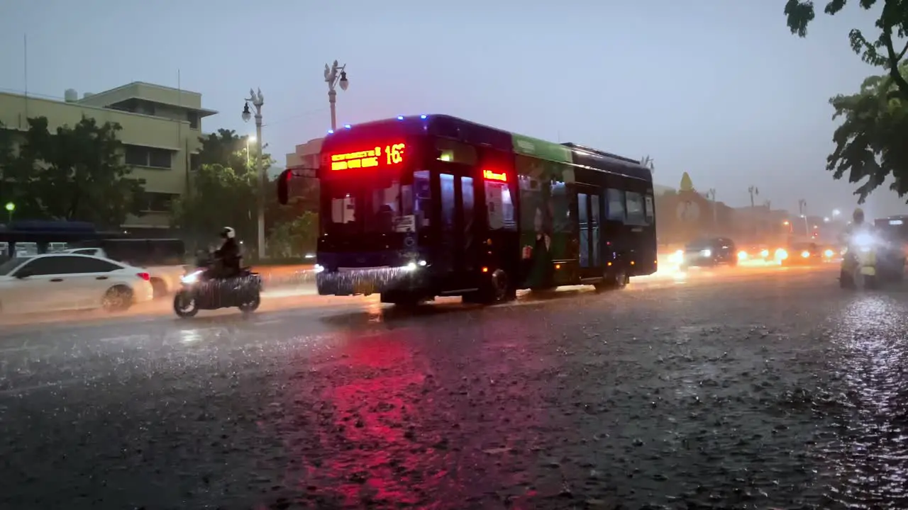 Traffic in the monsoon rainy season in Bangkok Thailand with the whole street flooded