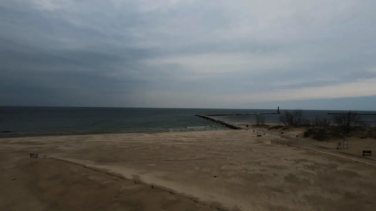 Waves crashing against a sandy shoreline in mid winter