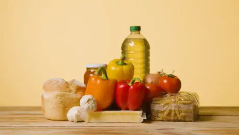 Studio Shot Of Basic Food Items On Wooden Surface And White Background 1