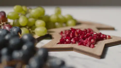 Close Up Of Red And Green Grapes With Pomegranate Seeds Celebrating Muslim Festival Of Eid