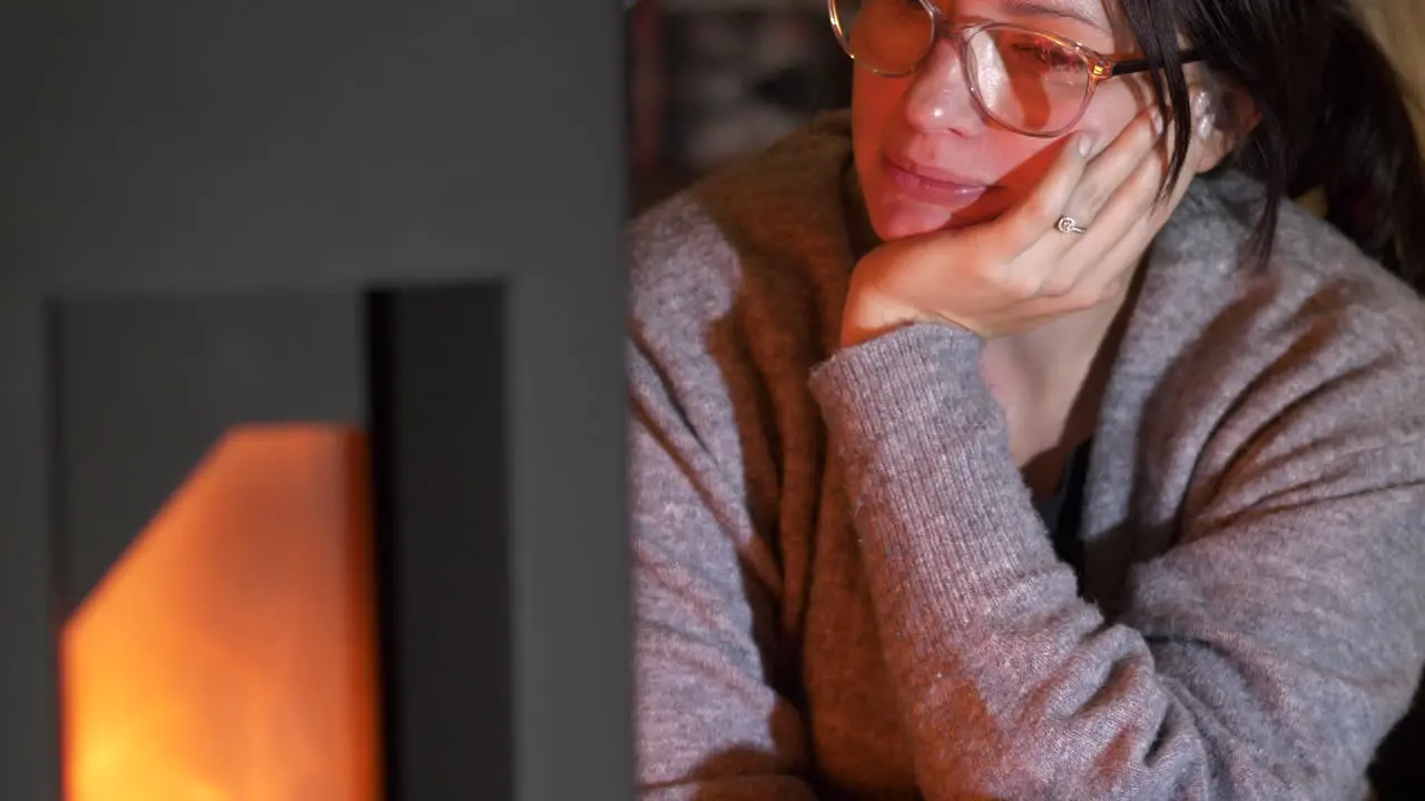 Young woman relaxes in front of fireplace Slow-motion