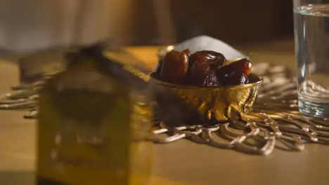 Bowl Of Dates With Glass Of Water On Table In Muslim Home Celebrating Eid 1