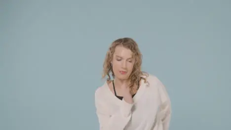 Studio Shot Of Young Woman Having Fun Dancing Against Blue Background 1