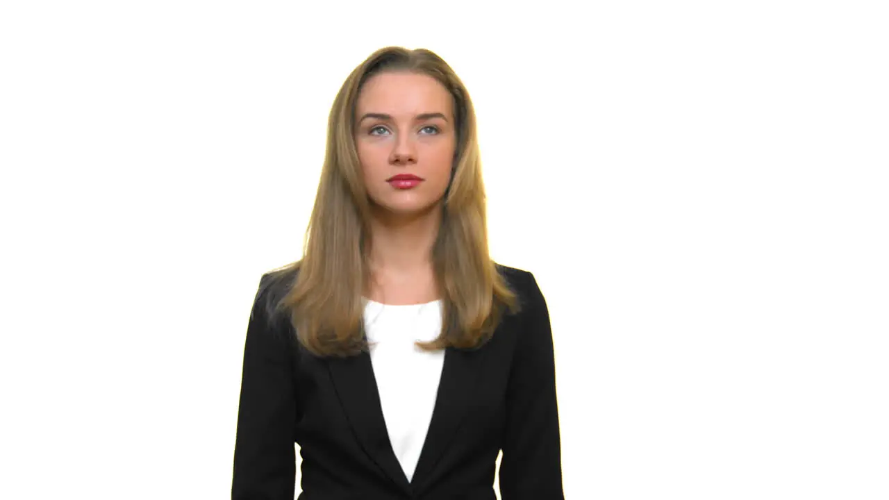 A beautiful young woman dressed in formal office wear swinging and grooving to some kind of music