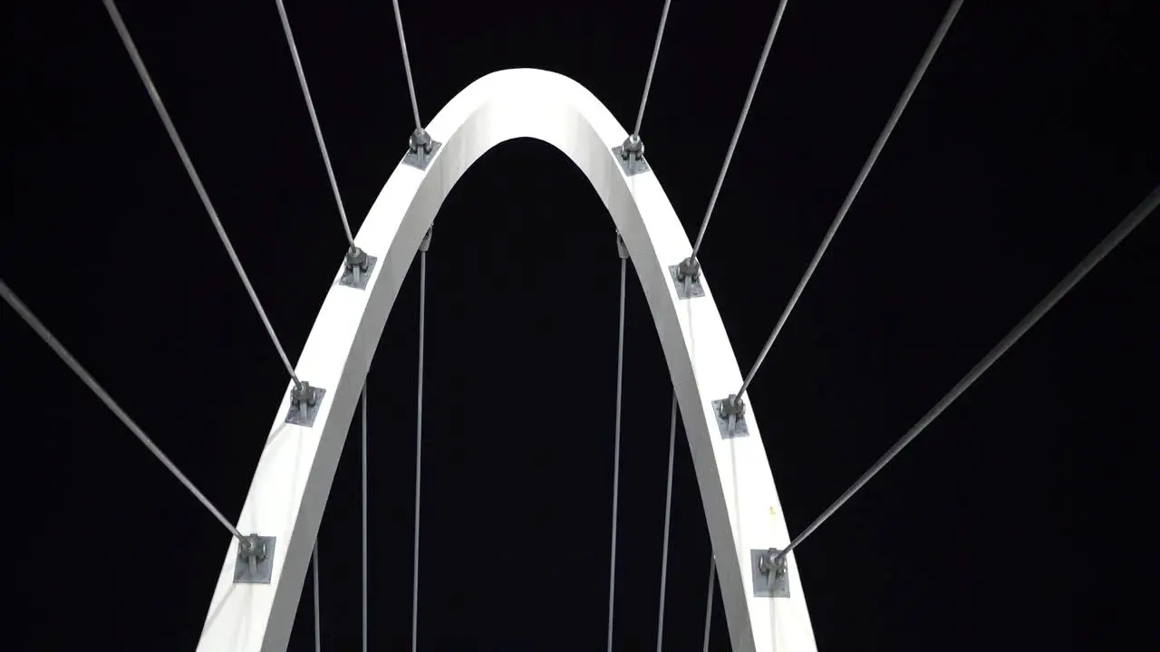 Abstract arch city bridge architecture with cables and metal frame at night