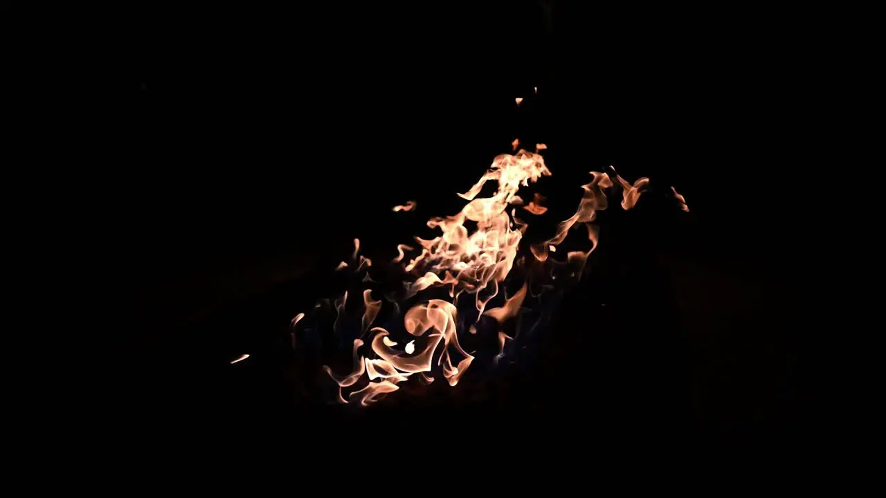 Single high contrast natural gas flame dancing late at night