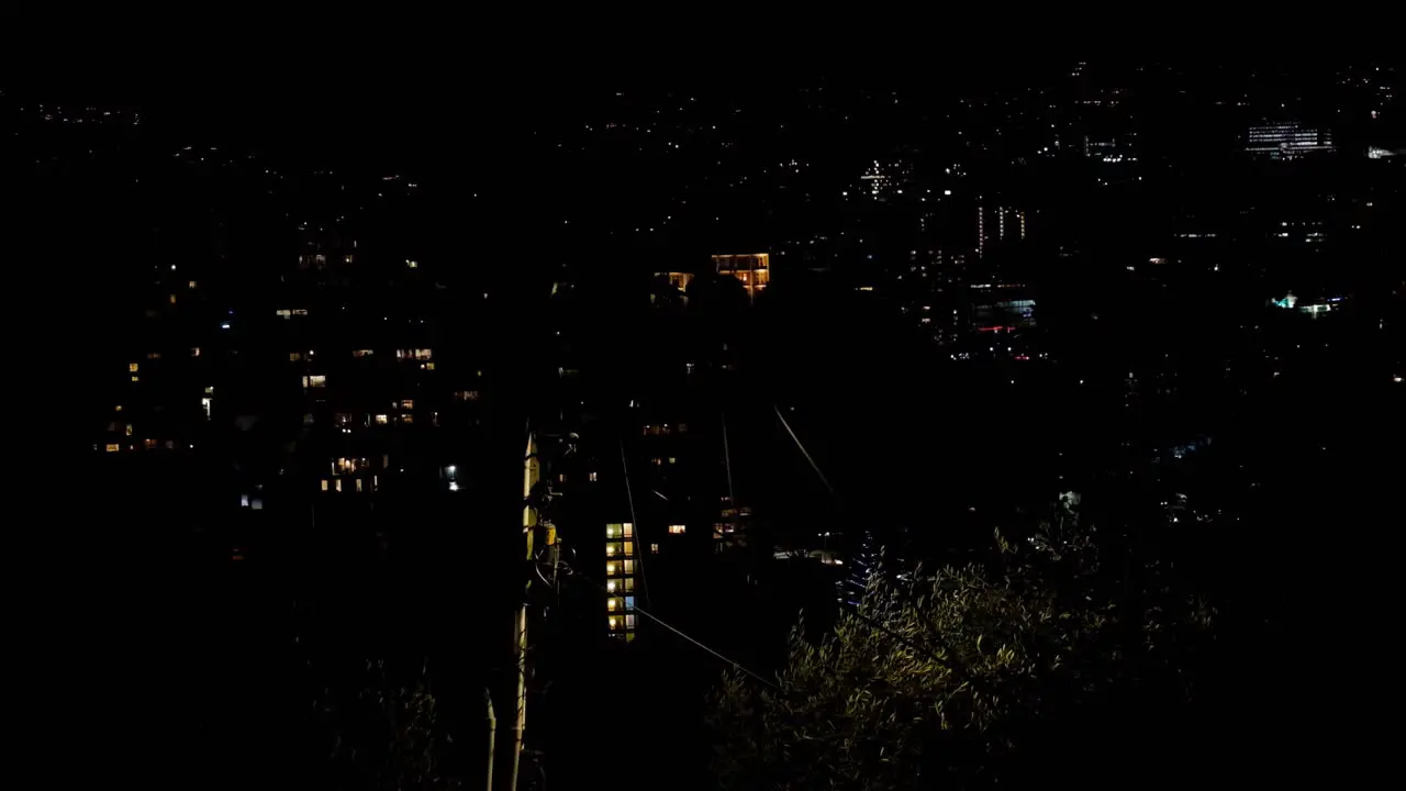 Warm glow of lights at night in urban capital city Wellington in New Zealand Aotearoa on a windy blustery night overlooking dark cityscape