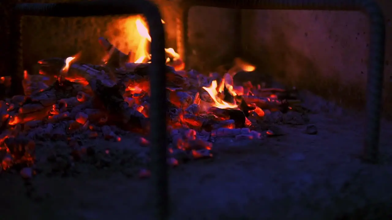 Fire embers and ash on a burning stone barbecue