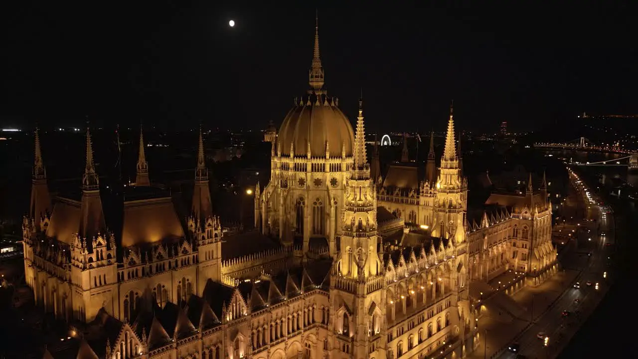 Drone Orbits Above Hungarian Parliament Building at Night in Budapest Hungary