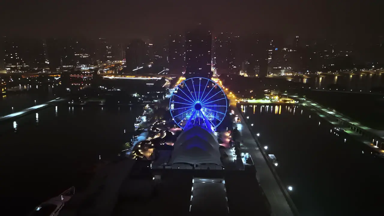 Drone shot tilting toward the Centennial Wheel at the hazy Navy pier in Chicago