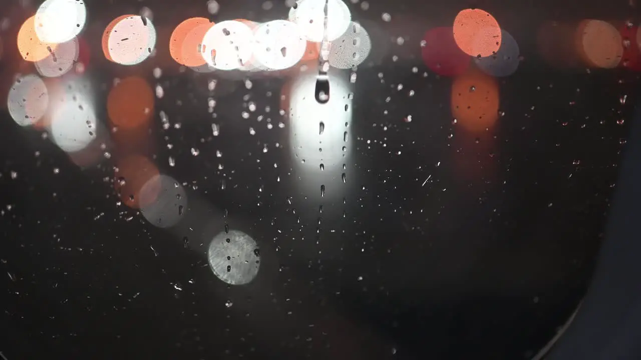 Rain at night on an airplane window