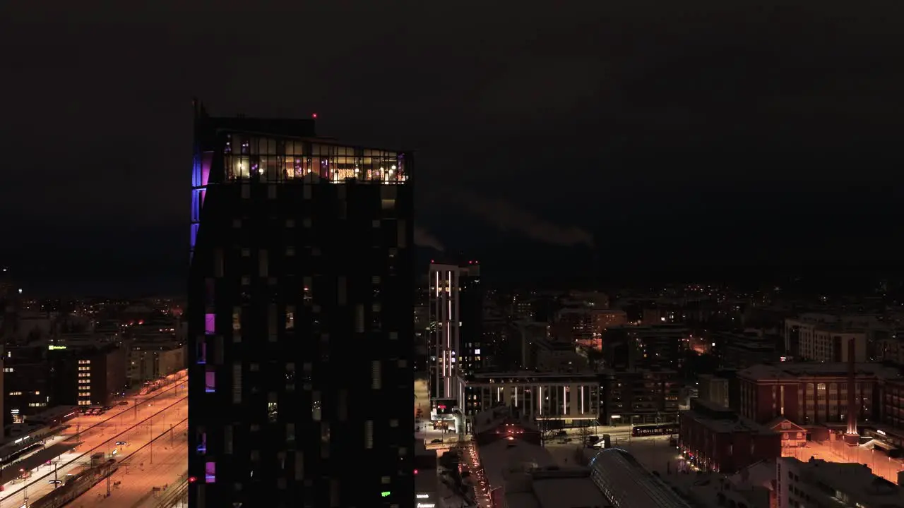 Aerial view passing the Torni hotel revealing buildings at the train station winter in Tampere Finland