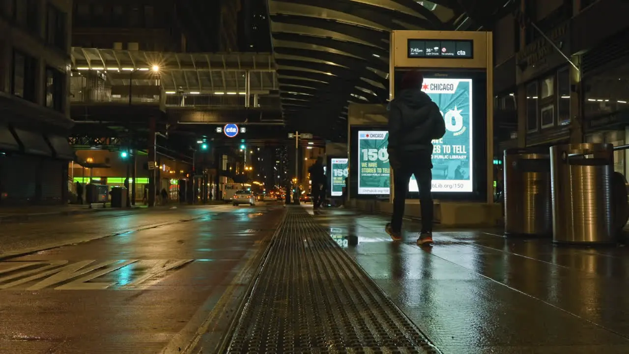 Quiet moist evening at a bus stop and CTA train station in downtown Chicago USA