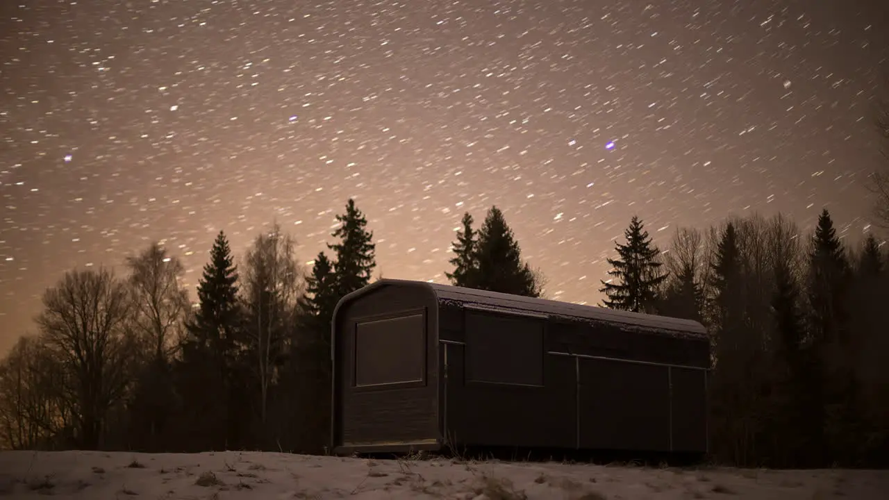 Black Thermowood Cabin Near Coniferous Forest At Night With Stars In The Sky