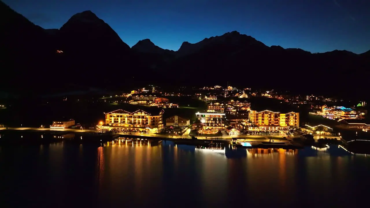 Aerial View Over Illuminated Pertisau Village At Night On The Achensee Lake In The Tyrol Region Of Austria drone shot