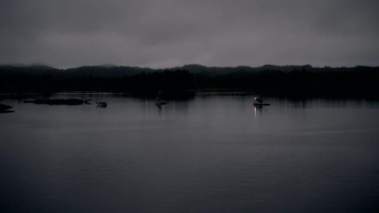 A lonely fishing boat at nighttime in a fjord along the southern coast of Alaska