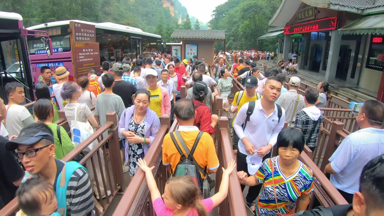 Crowds of people leaving the Ten Mile Gallery exit in the Zhangjiajie national park and queuing for the buses Hunan Province