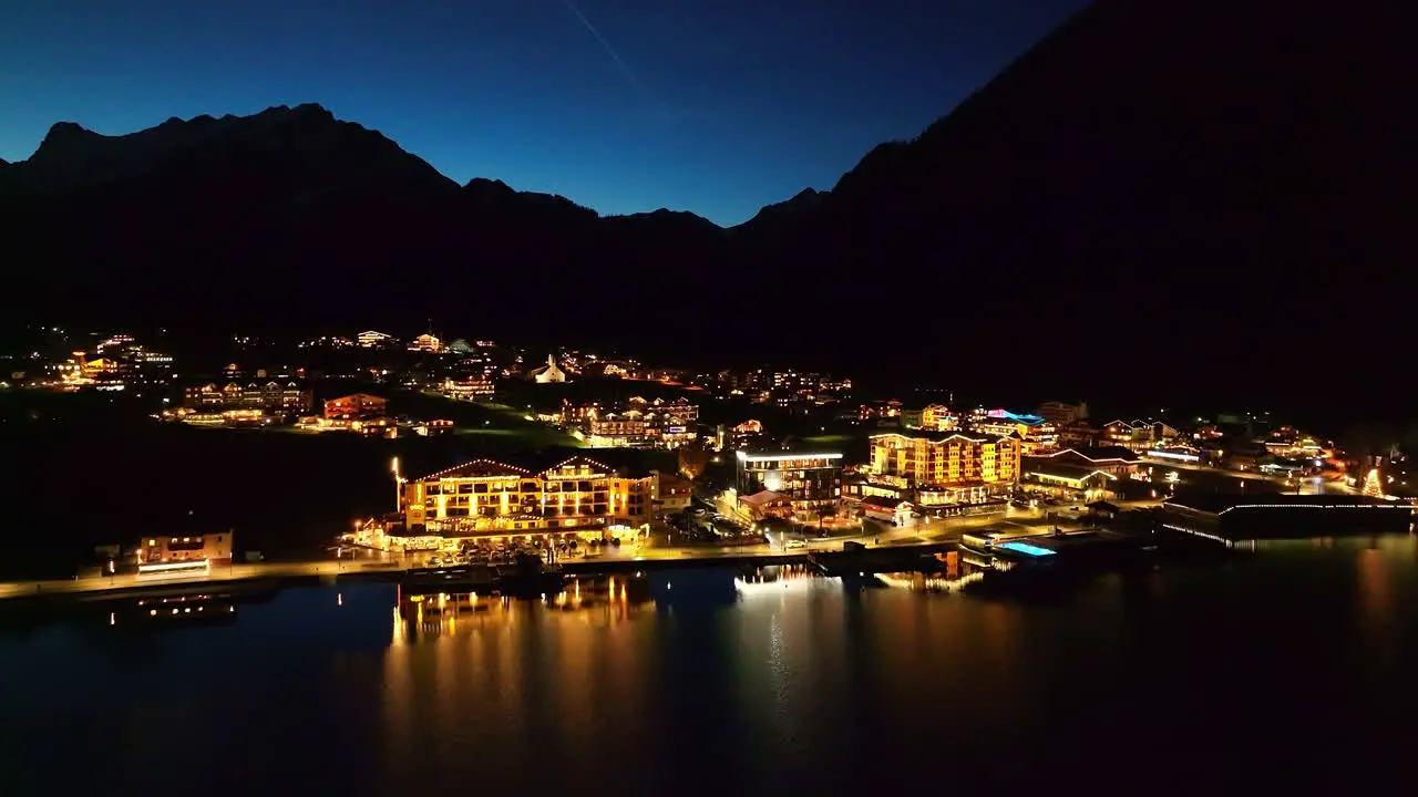 Pertisau Village With Illuminated Lights At Night In Austria aerial drone shot