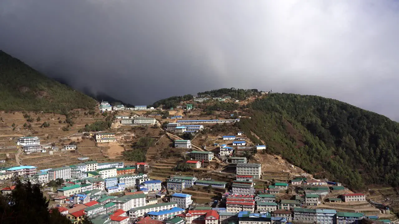 A high angle view of storm clouds passing over the small tourist town of Namche Bazaar in Nepal