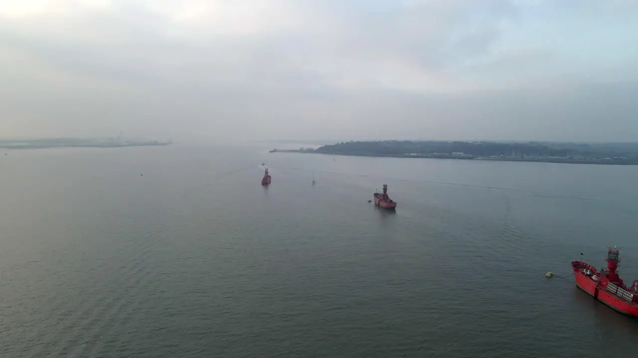 Old Lighthouse ships moored on river Orwell and river off Harwich drone footage