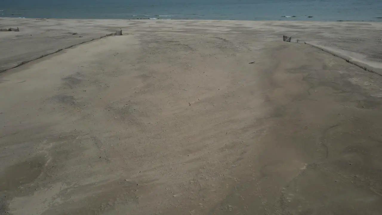 Rain soaked sand on a freshwater beach before a storm