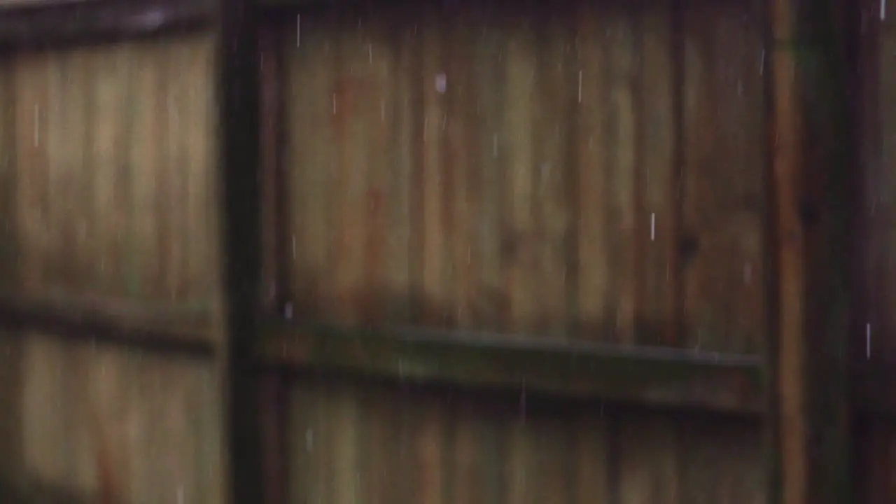 Steady Rain Falling in Front of Wooden Fence Super Slow Motion