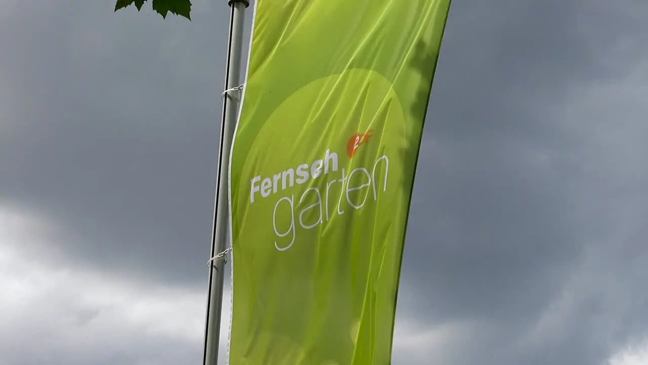 ZDF Fernsehgarten green Flag on a windy cloudy day Wiesbaden Germany