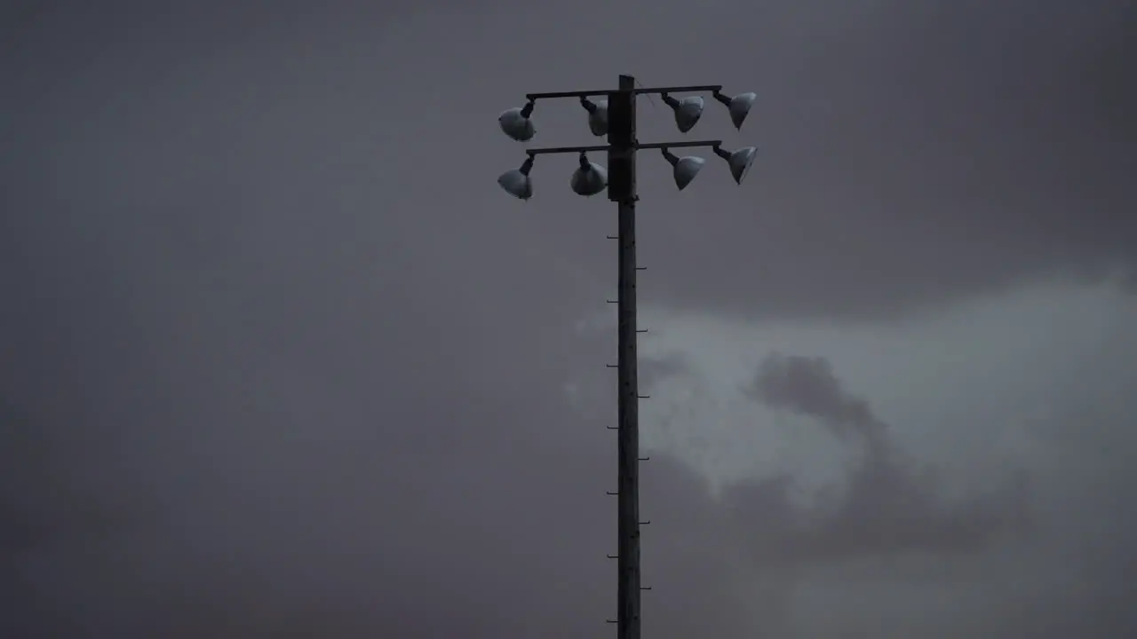 Baseball light pole swaying heavily in a thunderstorm