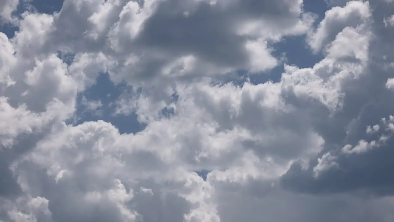 Timelapse of big fluffy clouds and darker stormy clouds