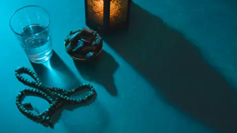 High Angle Tracking Shot of Dates Water Beads and Lantern On a Table