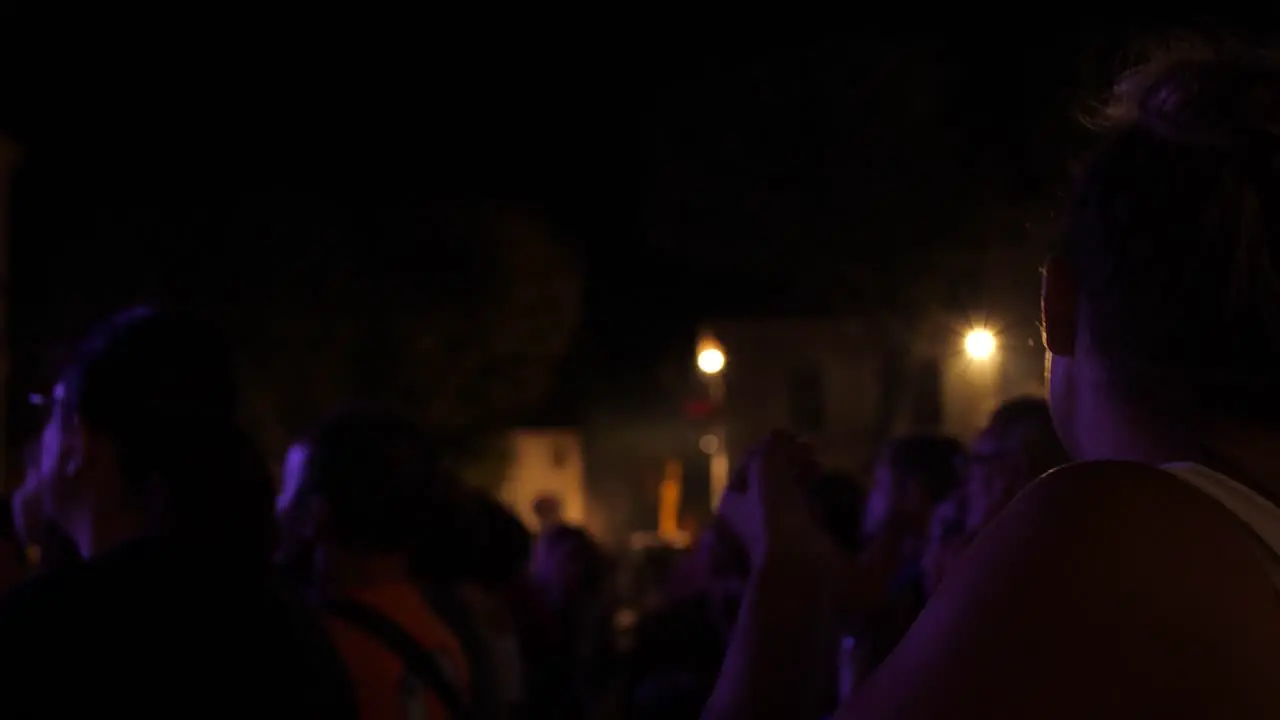 Woman whistling and cheering loudly for her favorite band on stage at a party