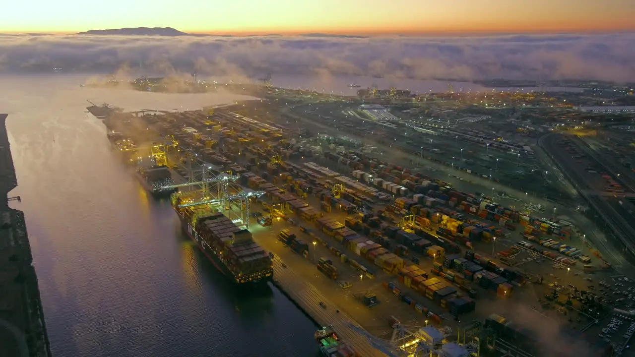 Nighttime sunset view of the Port of Oakland and the waterways along the harbor aerial reveal