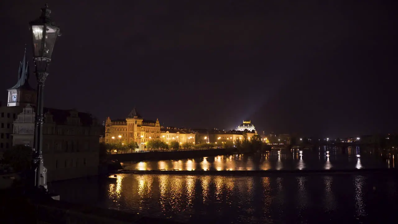 National theatre in Prague Czechia at night behind bridges over Vltava river