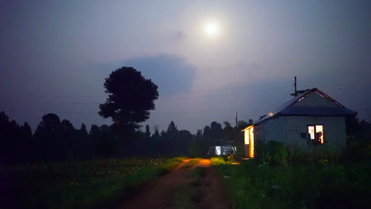 Rugged Nepal House at night with fire flies flying around