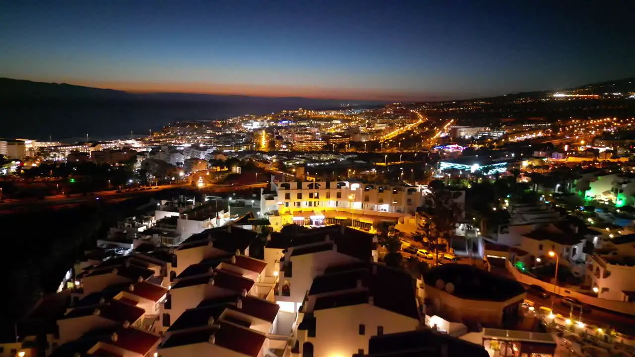 Captivating night flight over residential areas with a distant highway