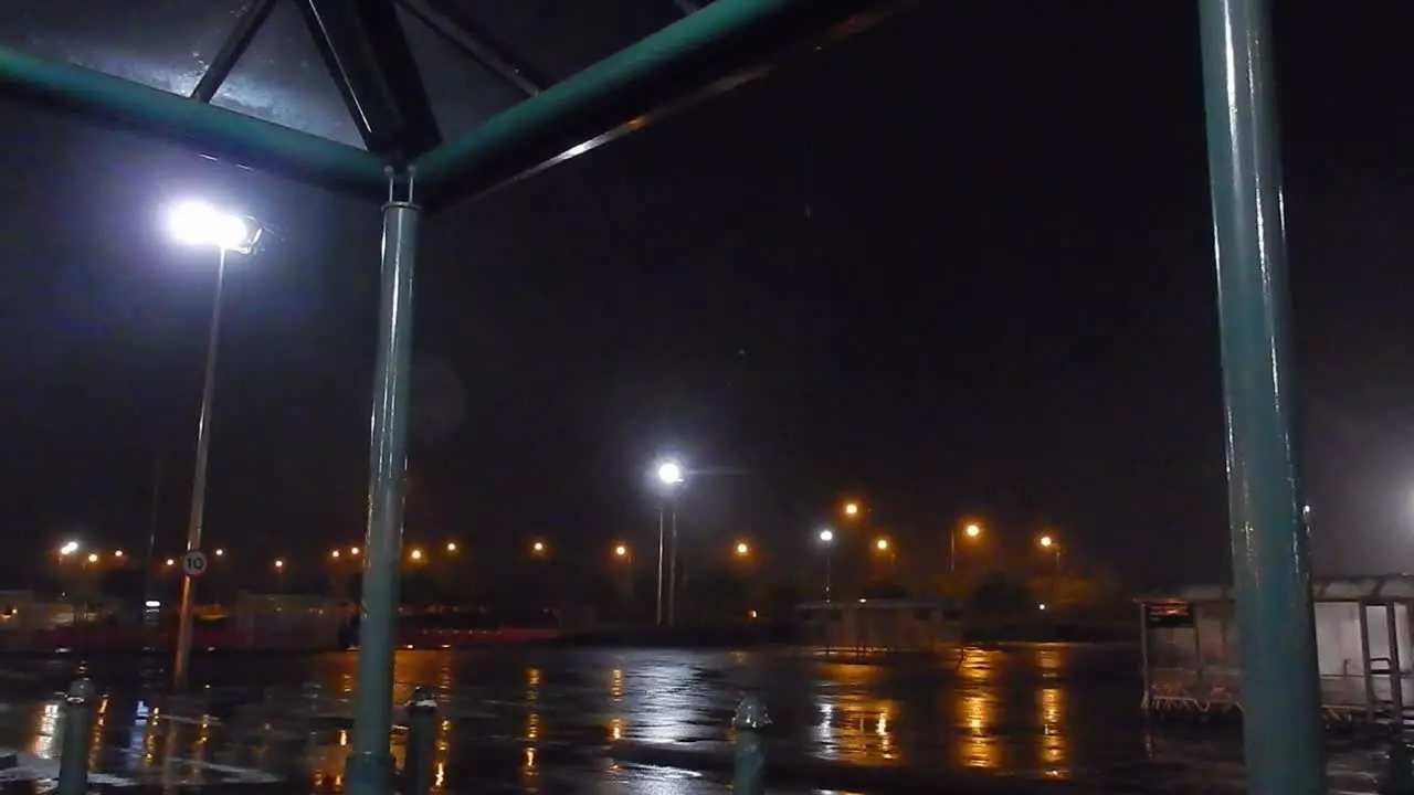 Storm Francis raining wet pouring blowing windy rainfall across British shopping store car park at night