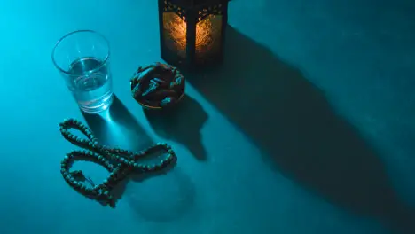 High Angle Shot of Dates Water Beads and Lantern On a Table