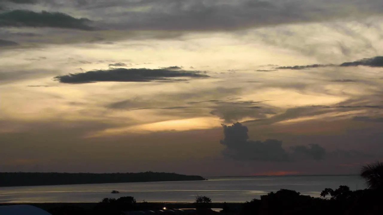 The Rio Negro or Black River that feeds into the Amazon River wide angle sunset time lapse with boat crossing at sundown