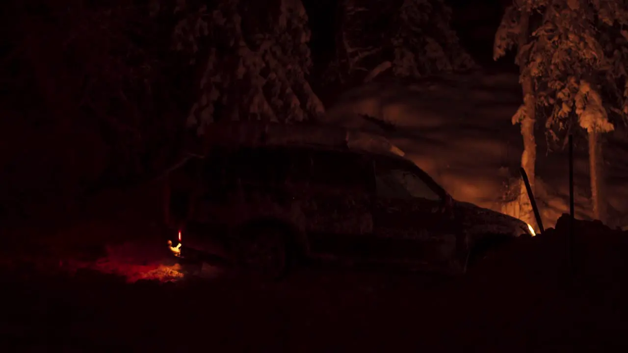 Side View Of A Snowy Car Parked In The Dark At Night In Winter