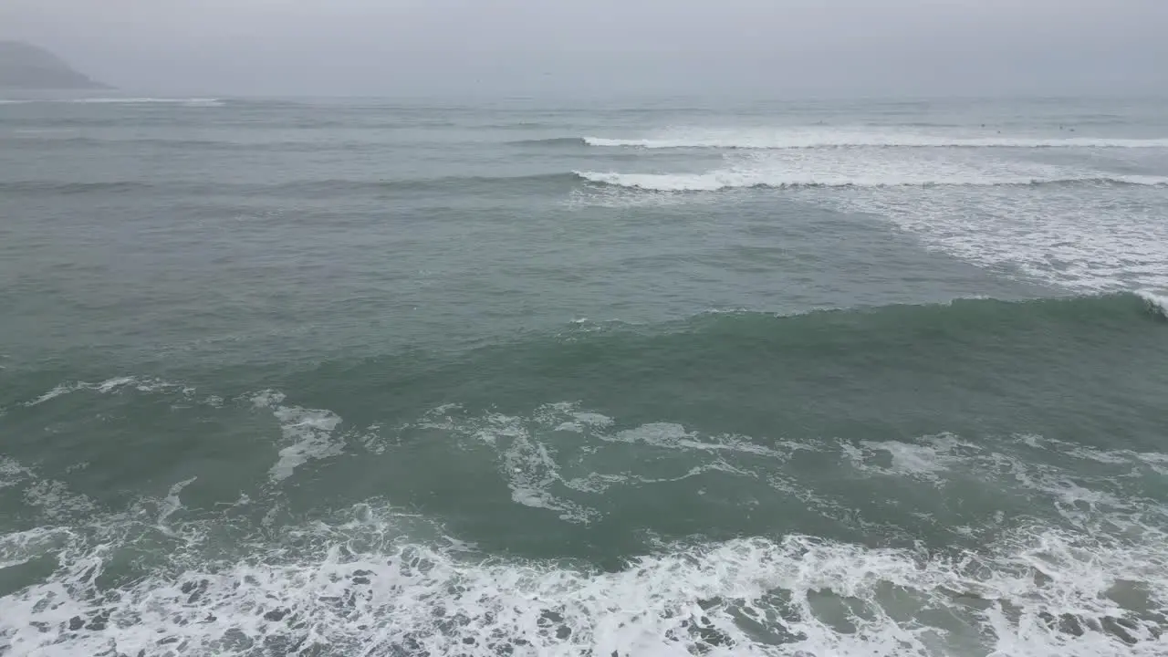 Slow aerial dolly shot forward from the beach