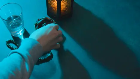 High Angle Tracking Shot of Dates Water Beads and Lantern On Table