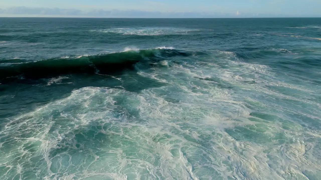 Seascape With Huge Foamy Waves Rolling Onto Shoreline