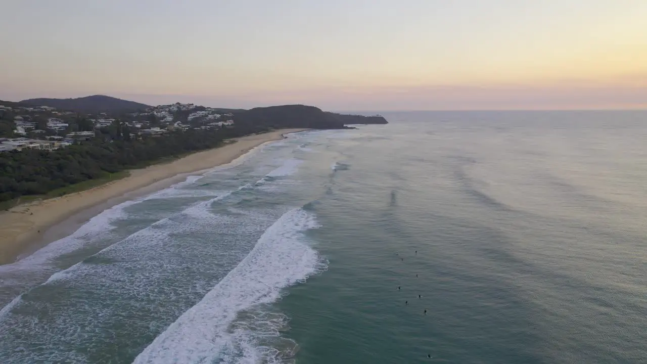 Foamy Waves Splashing Sandy Shore Of Sunshine Beach At Sunset In Queensland Australia aerial shot