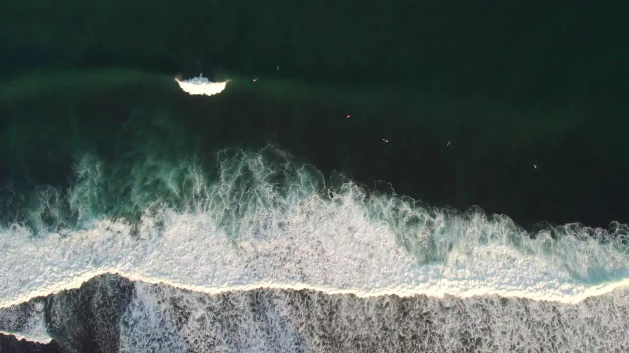 aerial top down of huge ocean waves in Indonesia bali island clean sea water